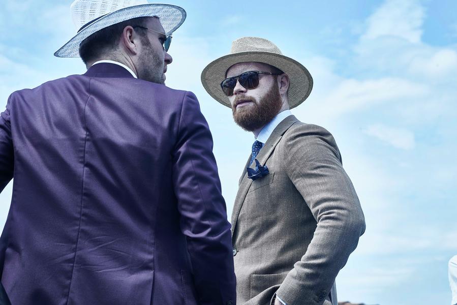 Boater - Paglietta Two hipster-style men wear a purple (left) and brown (right) suits and two boater