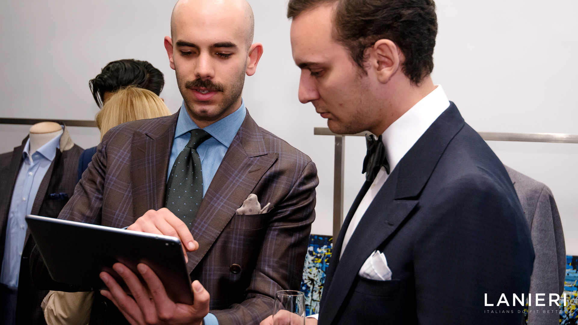 Un uomo mostra ad un altro uomo il funzionamento di un sito su un tablet