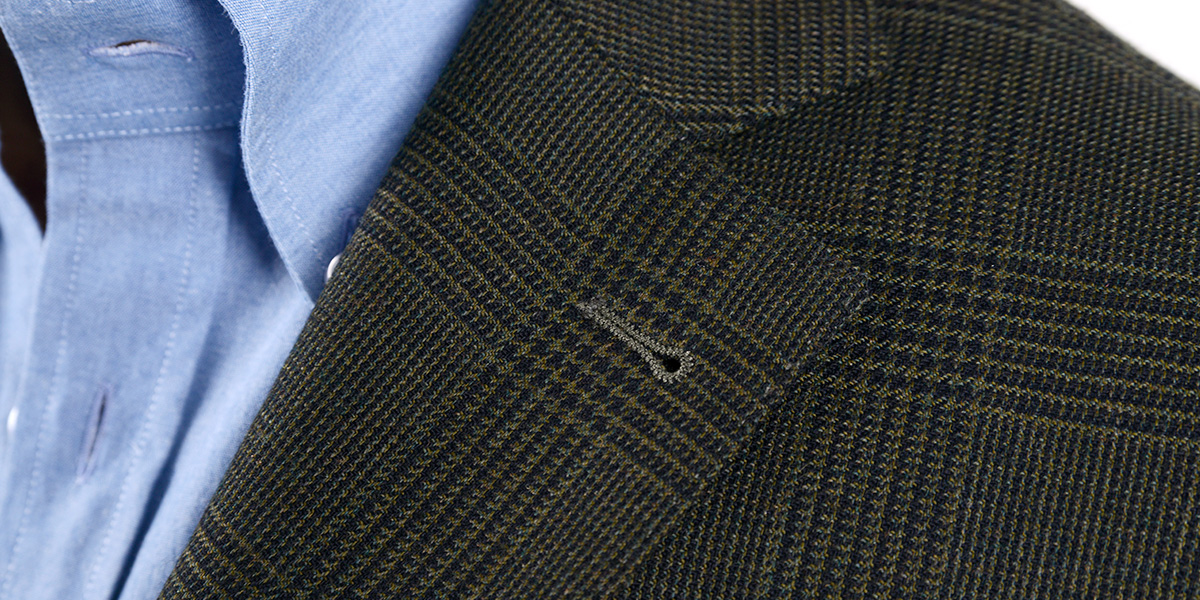 Step lapel also known as Step collar Classic notched lapels detail on a two-button Prince of Wales jacket