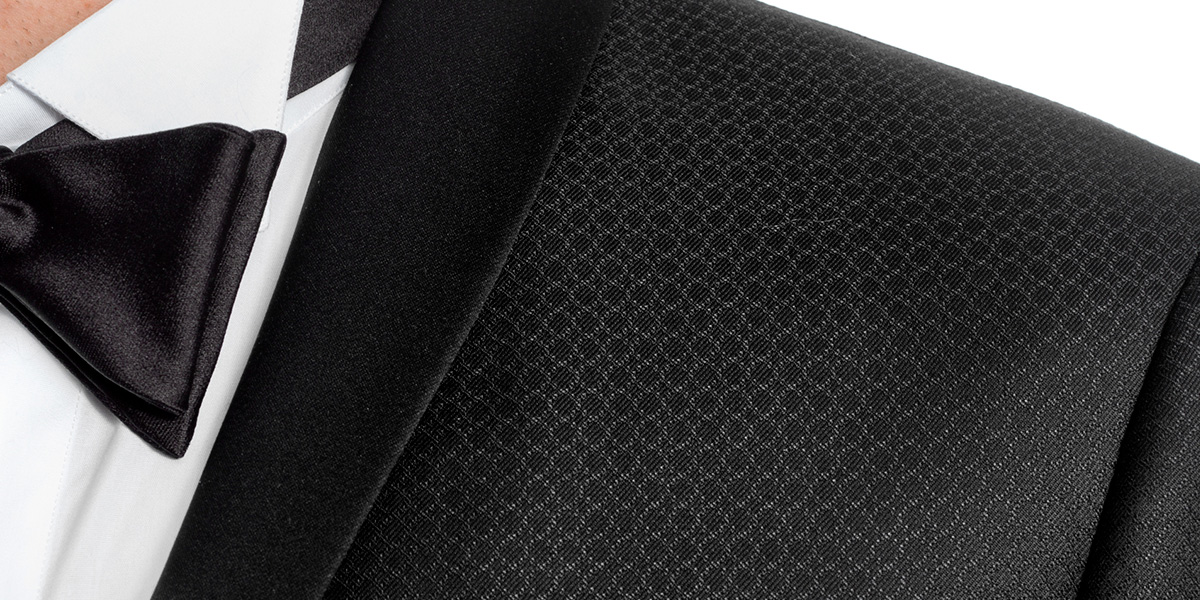 Detail of a roll collar on a black tuxedo Detail of a shawl collar on a black tuxedo